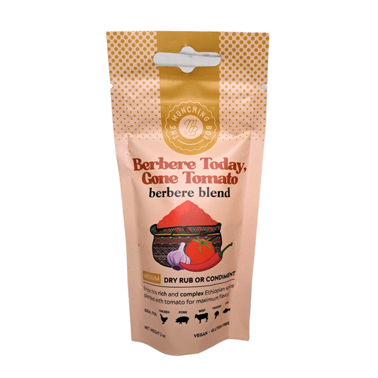 A close-up view of aromatic Berbere spice blend in a small dish. The spices are rich in color, featuring vibrant reds, earthy browns, and deep greens. This blend includes a mix of traditional Ethiopian spices, adding warmth and depth to culinary creations.